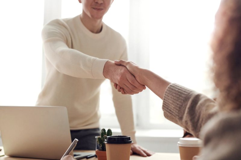 Employer and candidate shaking hands after a permanent placement